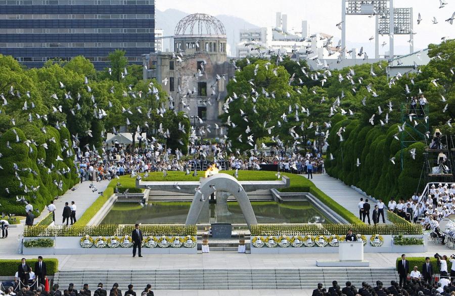 Doves fly over the Peace Memorial Park with a view of the gutted A-bomb dome at a ceremony in Hiroshima, Japan August 6, 2010. 