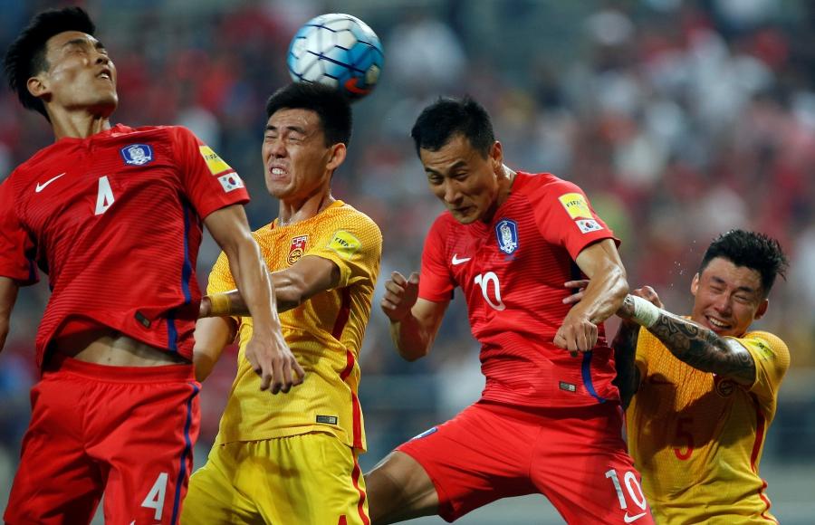 Li Xuepeng of China and Ji Dong-won of South Korea in action at the World Cup 2018 Qualifiers in Seoul, South Korea. 