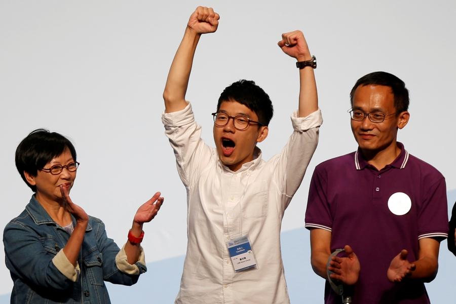 Student leader Nathan Law (C) celebrates on the podium after his win in the Legislative Council election in Hong Kong, China September 5, 2016.