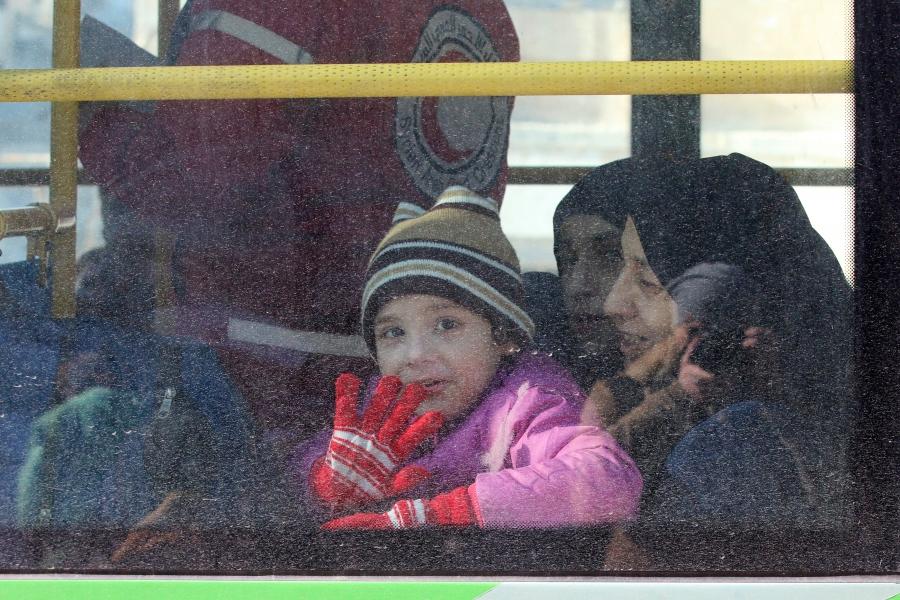 A child reacts from inside a bus evacuating people from a rebel-held sector of eastern Aleppo, Syria December 15, 2016. 