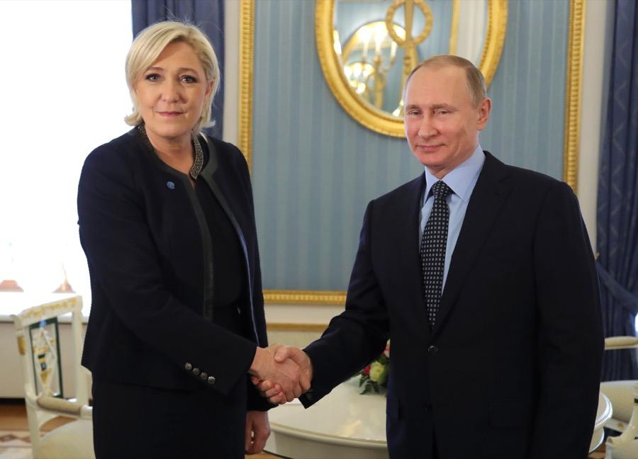 President Vladimir Putin shakes hands with Marine Le Pen