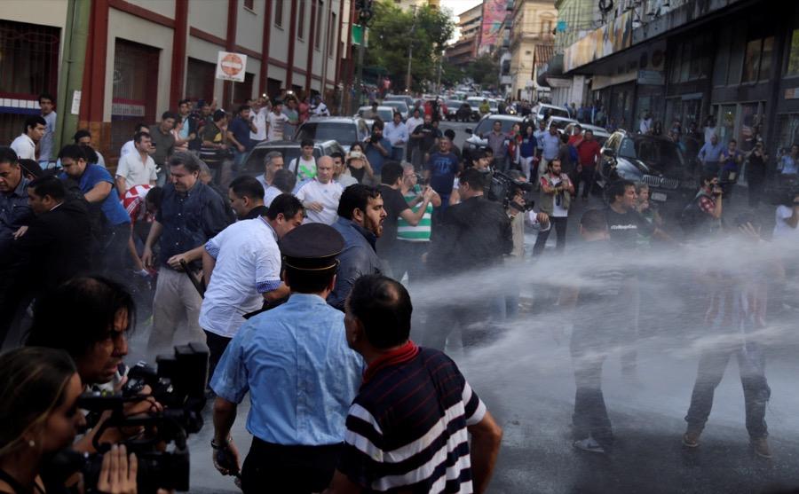 Protesters clash with police during a demonstration on March 31 outside congress in Asunción, Paraguay, against a possible law reform to allow for presidential re-election.