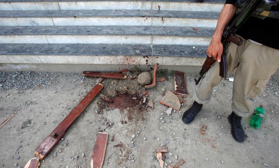 A policeman stands guard over evidence at the entry to the dorm where Mashal Khan, accused of blasphemy, was killed by a mob at Abdul Wali Khan University, in Mardan, Pakistan, April 14, 2017.