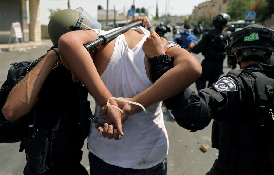 Israeli security forces arrest a Palestinian man following clashes outside Jerusalem's Old city.