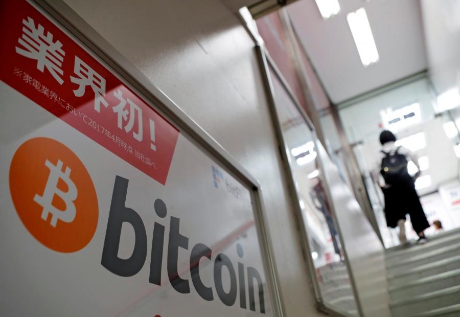 A logo of Bitcoin is seen on an advertisement of an electronic shop in Tokyo, Japan September 5, 2017. 