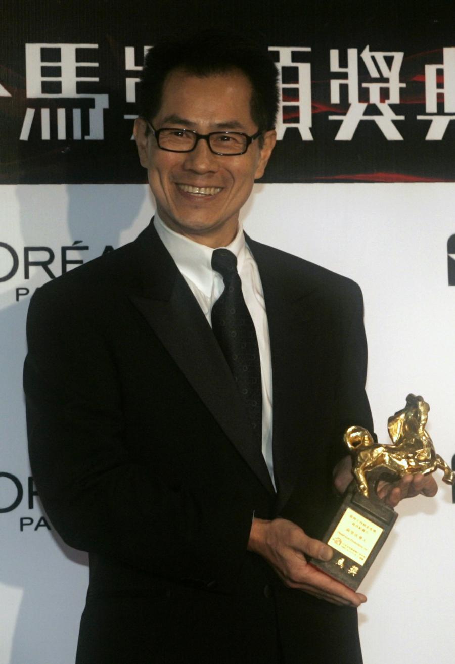 Director Arthur Dong poses with the award