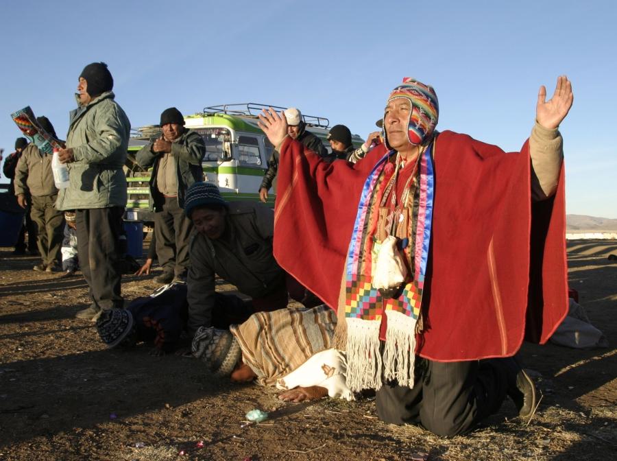 Bolivian Aymara indians receive the first rays from the sun during a traditional Aymara winter solstice ceremony in Taraca, south of La Paz. The ceremony, 2004, marked the year 5512 of the Aymara calendar. 