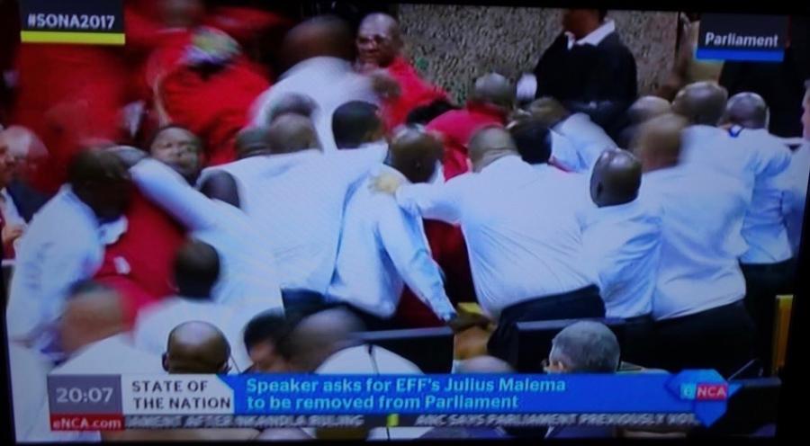 South African opposition parliamentarians struggle with officers trying to remove them before President Zuma's State of the Nation address in February 2017
