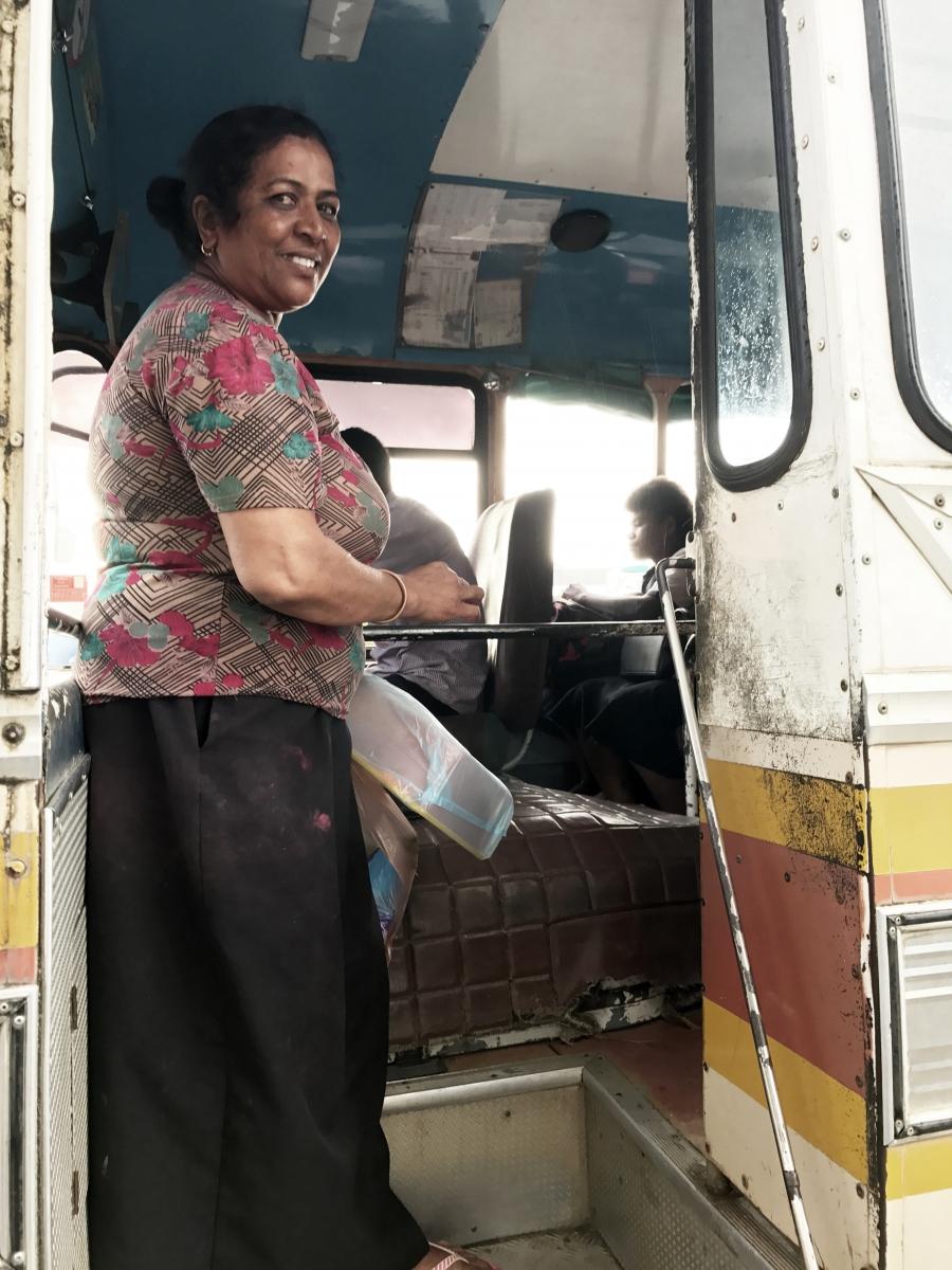 Sunila Wati boards a bus back to her village.