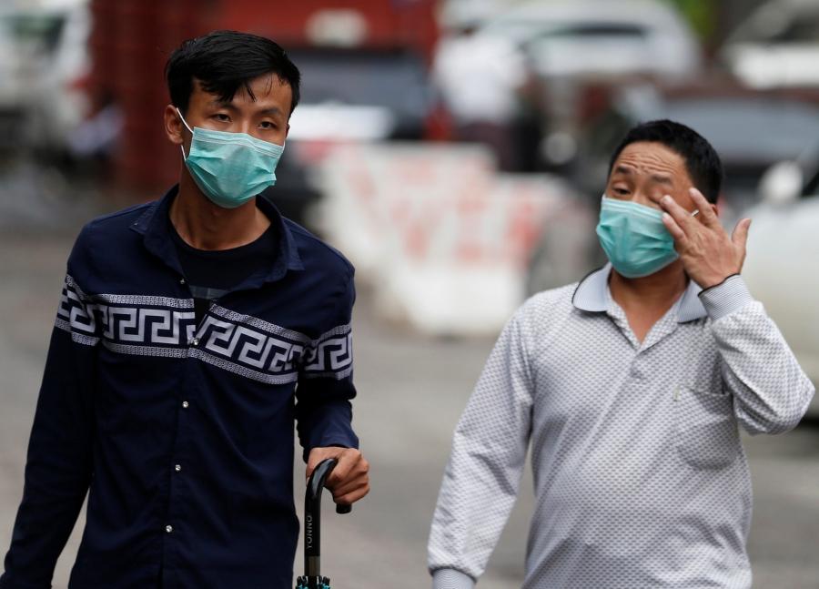 Men wear masks to protect themselves from H1N1 in Yangon, Myanmar.