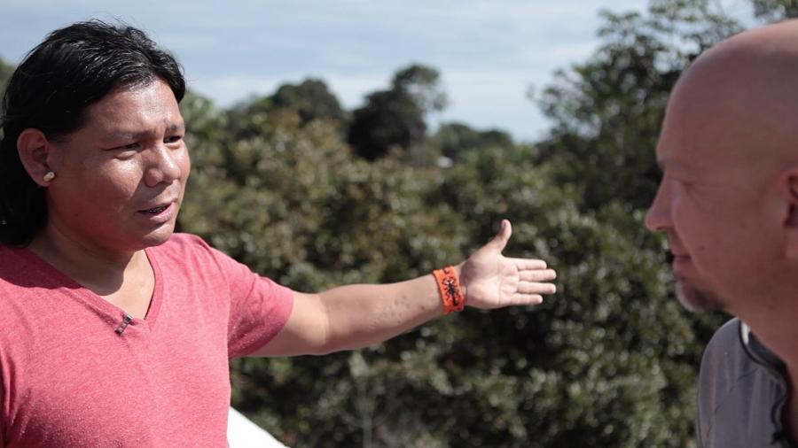 Xavante activist Hiparidi Toptiro stands on a bridge showing the border between his people's lands and the soy farms.