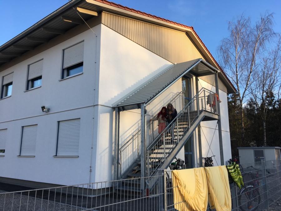Two Daas sisters exit the refugee housing complex in Traunreut, Bavaria, where they are living until they can find their own permanent housing.