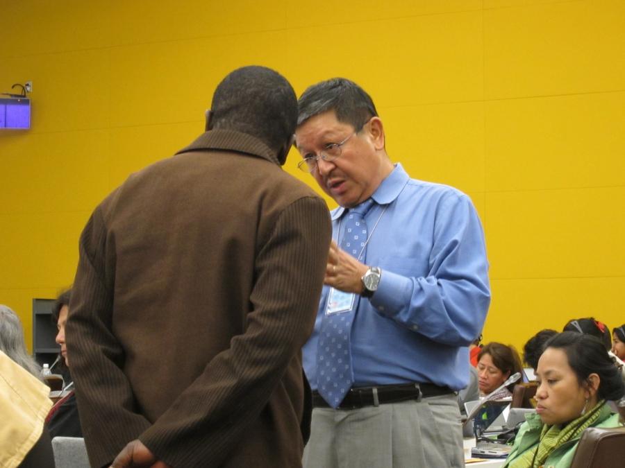 Navin Rai (right), the World Bank's top advisor on indigeneous peoples affairs from 2000 to 2012, talks with a member of the United Nations Permanent Forum on Indigenous Issues during a conference.