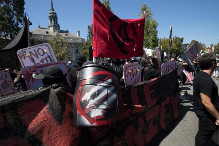 Three downward arrows, shown on an antifa activist’s shield, also is a symbol of the far-left movement.