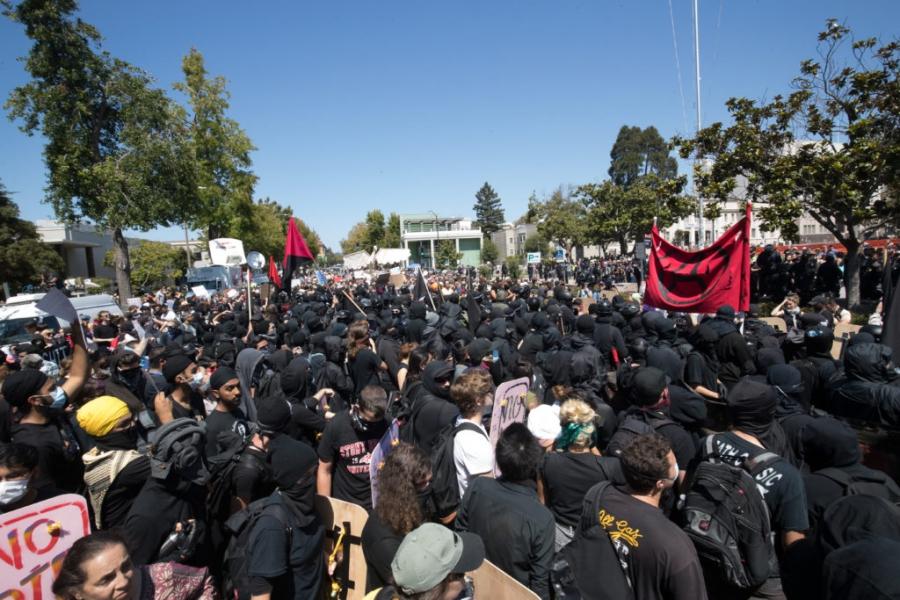 Antifa activists face off against Berkeley police, who lined up between protesters and the Martin Luther King Jr. Civic Center Park.