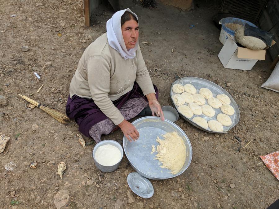 Wadha Khalaf makes bread for her family on Mount Sinjar.
