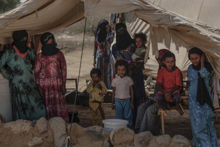 A family stands inside their tent in Beni Hassan, Hajjah. In December, the United Nations said more than 2.5 million had been forced from their homes in Yemen.
