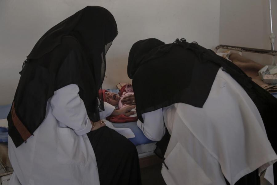 Nurses at the malnutrition clinic of al-Gomhouri hospital in Sadaa attend to a 4-month-old. There are only five working malnutrition clinics in the country.
