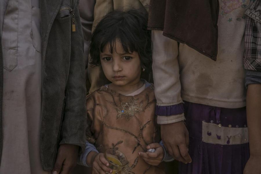 Fatima, 2, stands between her four siblings in northern Yemen.
