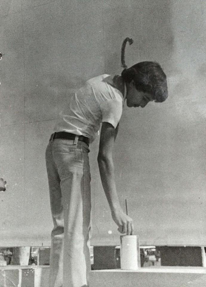 A 1981 photo of Angel Boligán, then around 16, painting a mural in his hometown of San Antonio de los Baños, Cuba.
