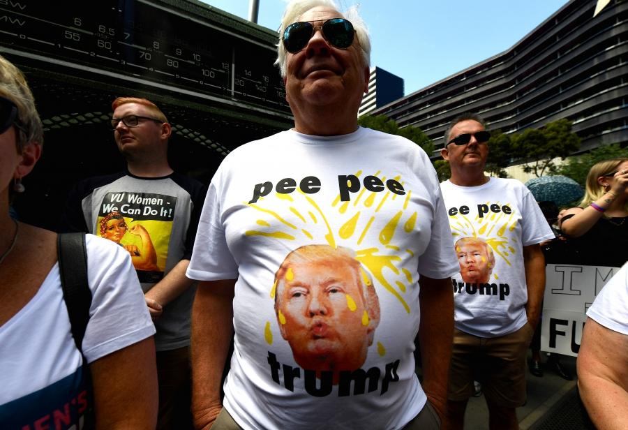 Protesters wearing shirts displaying a picture of US President Donald Trump