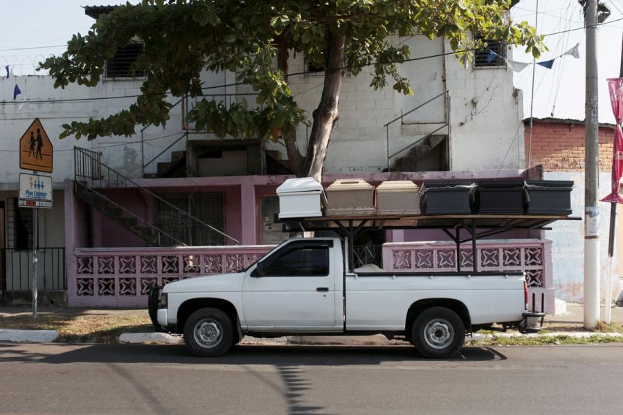 A pick-up truck transports unfinished coffins to another workshop in Jucuapa.