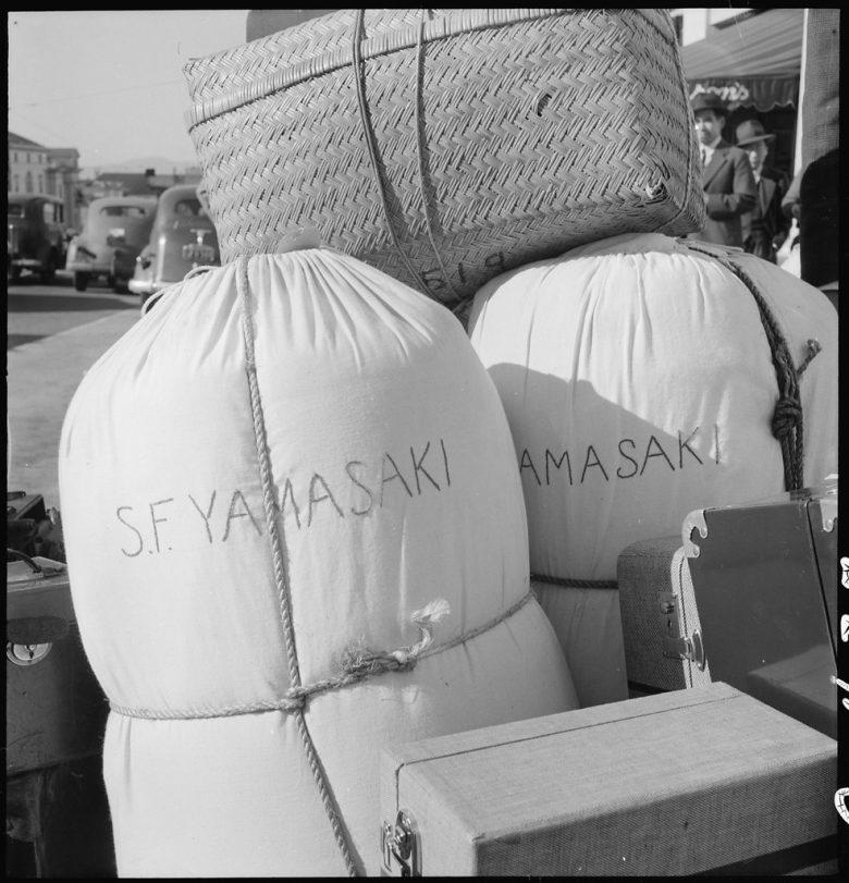 Two bedrolls, luggage and a large box. Names on the side of bedrolls read "S.F. Yamasaki"