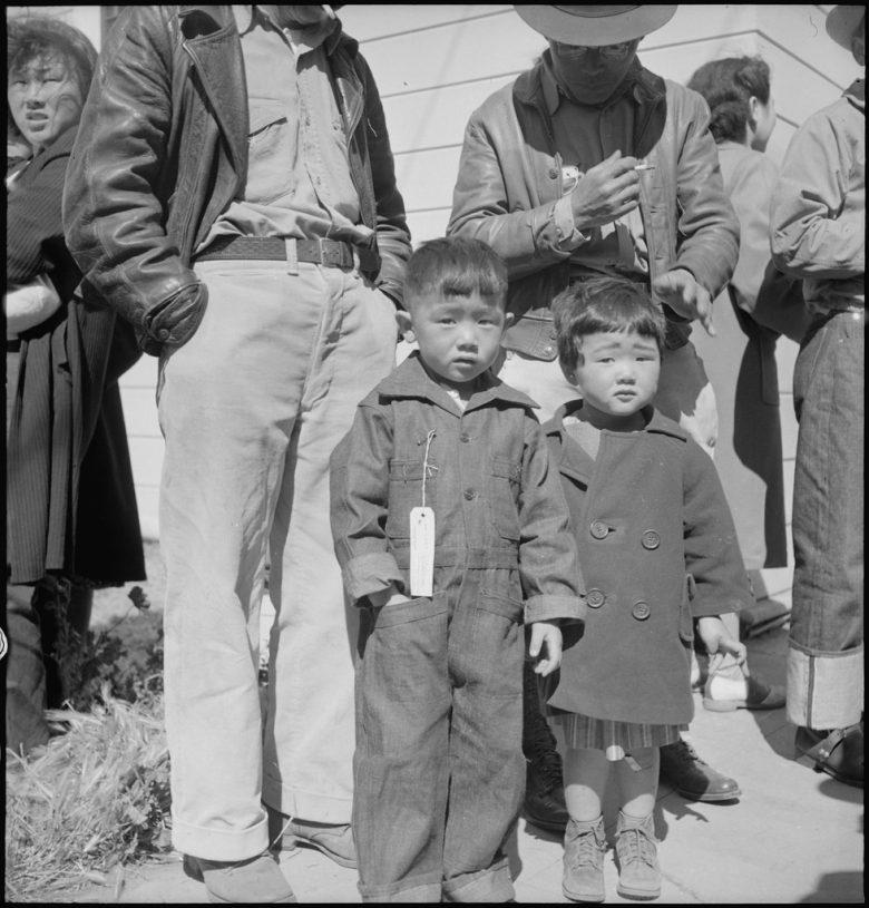 Two young children in traveling clothes
