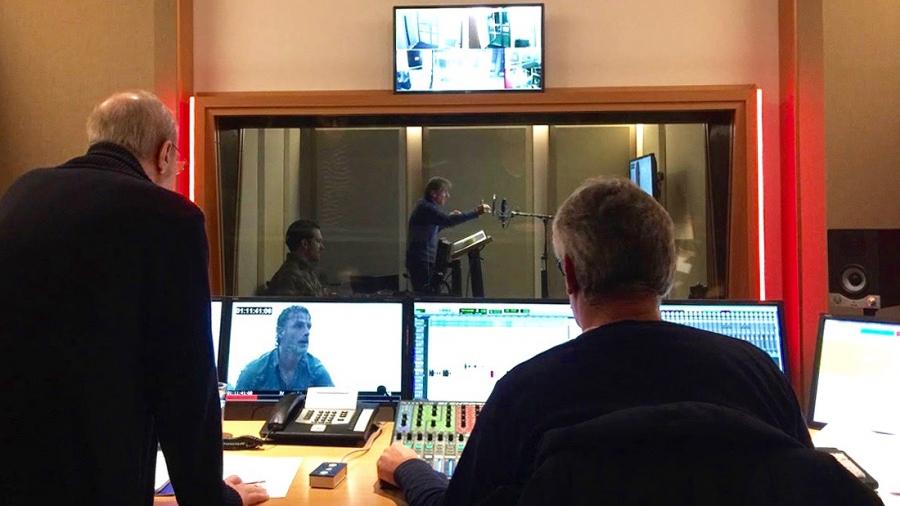 Inside the EuroSync studios in Berlin, German voice actor Victor Neumann (far center) voices the part of Rick Grimes on The Walking Dead, while dubbing director Hans-Jürgen Wolf and an engineer look on.