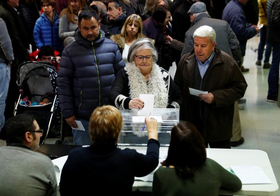 A woman casts her ballot Vic, Spain, Dec. 21, 2017.