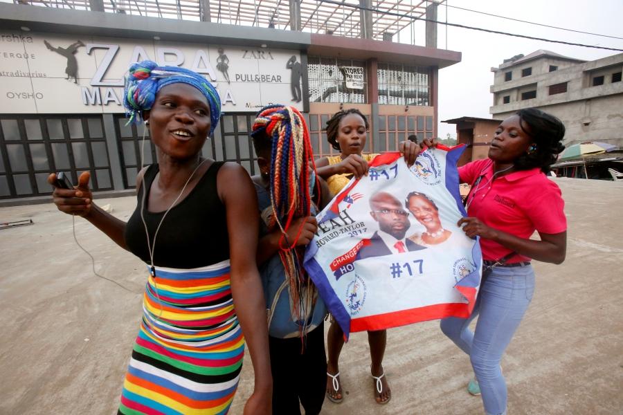 Supporters of George Weah, former soccer player and presidential candidate of Coalition for Democratic Change (CDC), celebrate after the announcement of the presidential election results in Monrovia