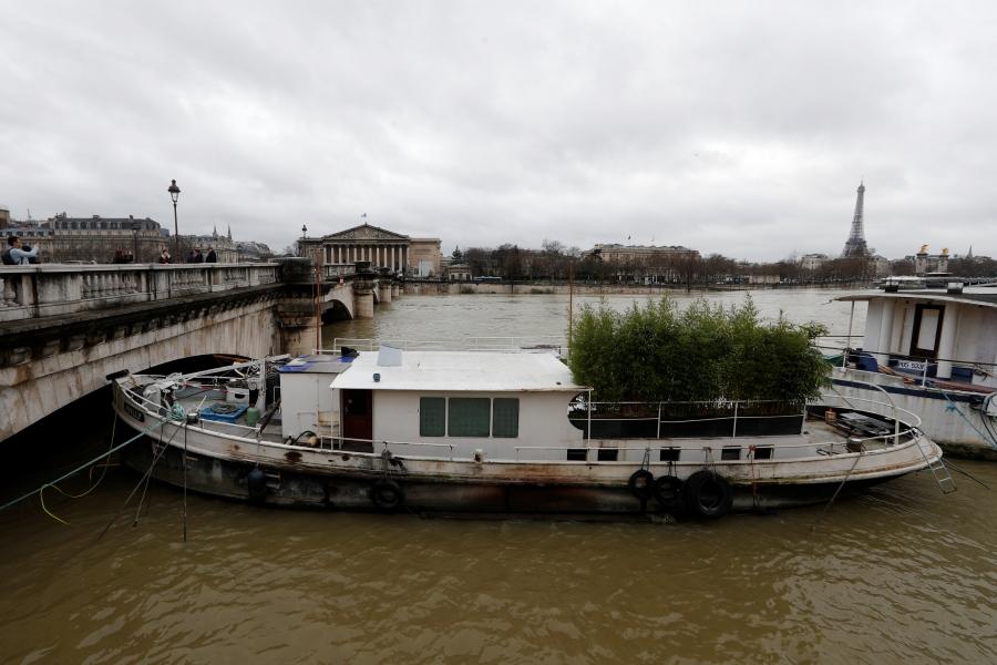 A view shows a peniche boat that is moored along the flooded banks of the River Seine.