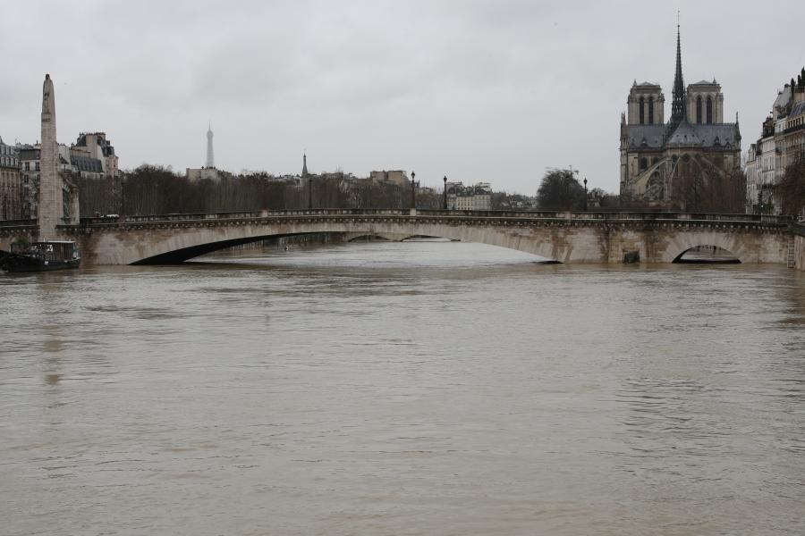 The rear of the Notre Dame Cathedral is seen as the muddy Seine River covers its banks.