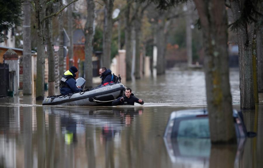 Paris police divers use a small boat to patrol a flooded street of a residential area in Villeneuve-Saint-Georges, near Paris. 