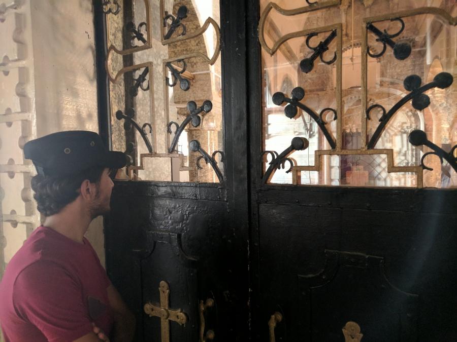 Ibrahim, 17, looks through the gates of a church damaged by ISIS fighters in Bartella, Iraq. He says his Christian faith helped him survive two years as an ISIS prisoner. But since his release, the ordeal has made him question religion.