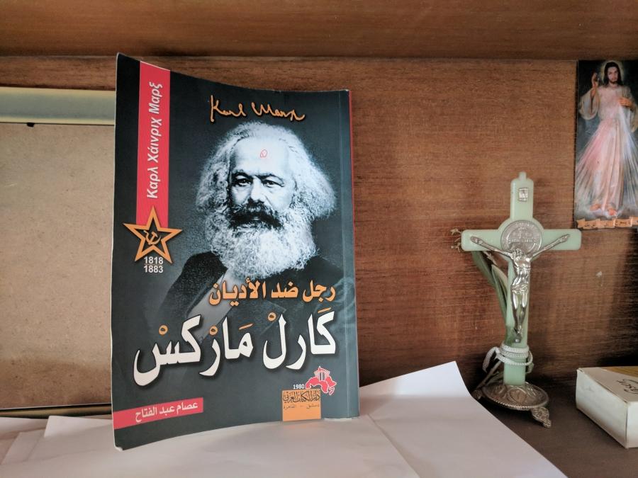At Ibrahim's home, Karl Marx shares a bookshelf with Jesus Christ.