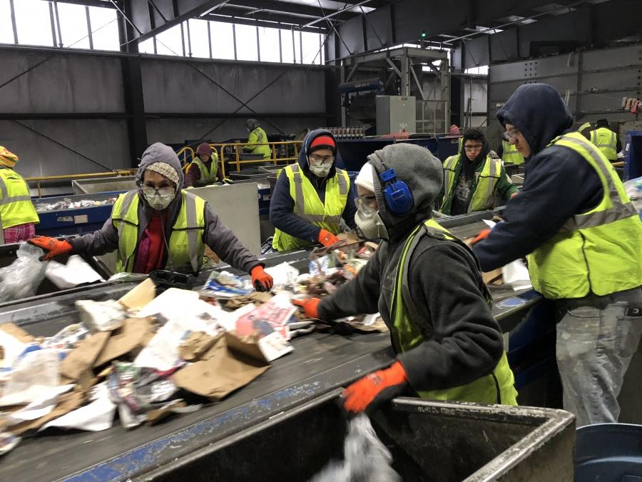 Workers manually sort trash from recycling at E.L. Harvey & Sons. Approximately 15 percent of the recycling that’s collected here is unusable trash. 