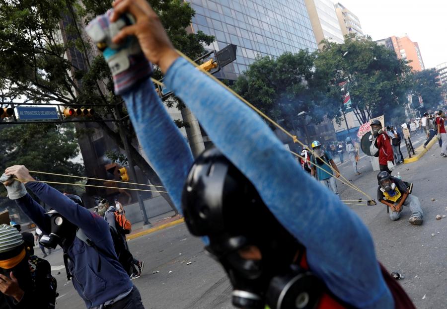 Demonstrators use a giant slingshot while clashing with security forces during a rally against Venezuela's President Nicolas Maduro in Caracas, Venezuela, May 20, 2017. 
