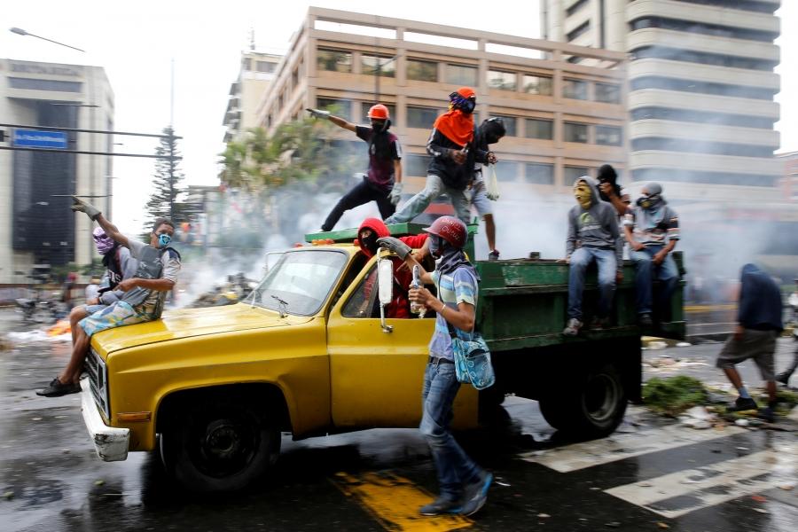 Demonstrators ride on a truck while rallying against Venezuela's President Nicolas Maduro's government in Caracas