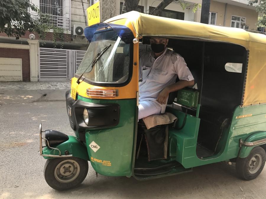Imran Khan, a local “autowallah” — a driver of a motorized three-wheel passenger vehicle — wears a mask to protect himself from polluted air. Khan tries to get more autowallahs to wear masks, too, but few have followed his lead.