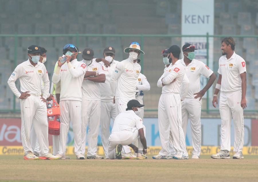 Sri Lankan cricket players wear masks during a match against India in Delhi, Dec. 5, 2017. Play was interrupted multiple times while the Sri Lankans complained about air quality levels, which were at least 15 times higher than World Health Organization st