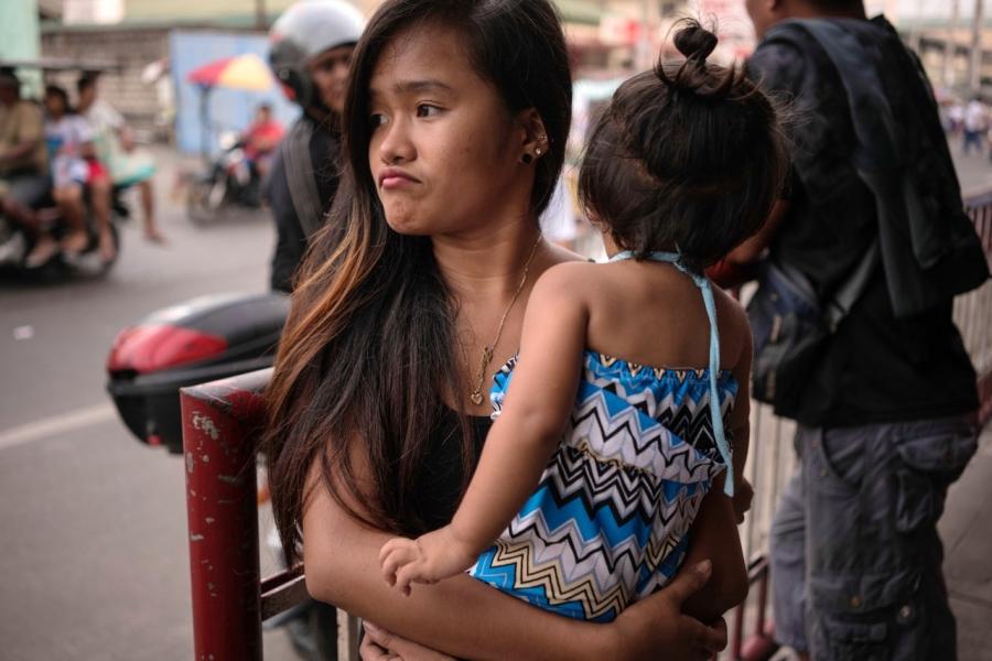Jazmine Durana walks with her daughter Hazel in Navotas City, north of Manila, Philippines. Durana’s partner was killed a year ago by masked men.