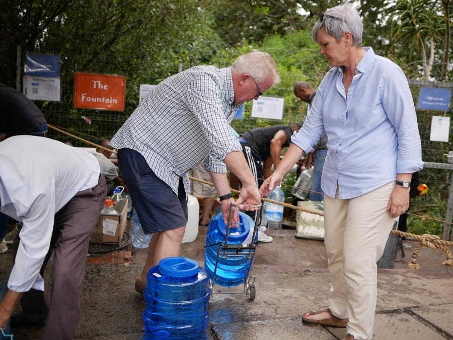 Sabine and Nils Heckscher hold jerricans to collect water at a natural spring in Newlands, Cape Town. 
