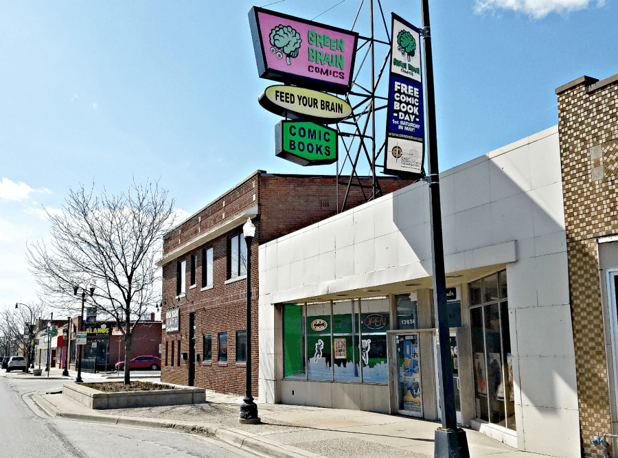 Storefront of Green Brain, simple white walls and large sign