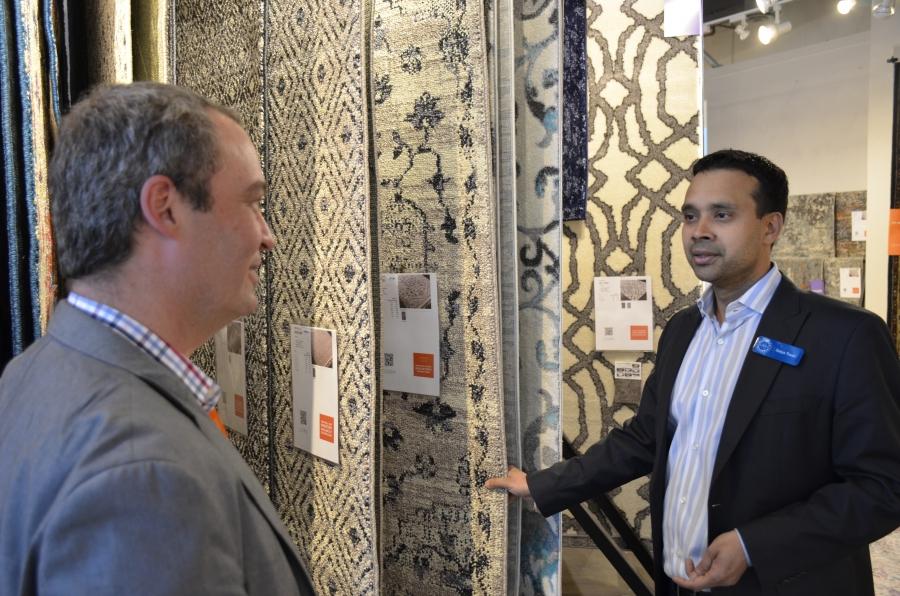 Satya Tiwari (right) president of the Atlanta-based company Surya, shows a rug to John Mulliken, the CTO of Wayfair, one of the world’s largest online sellers of furniture and home furnishings.