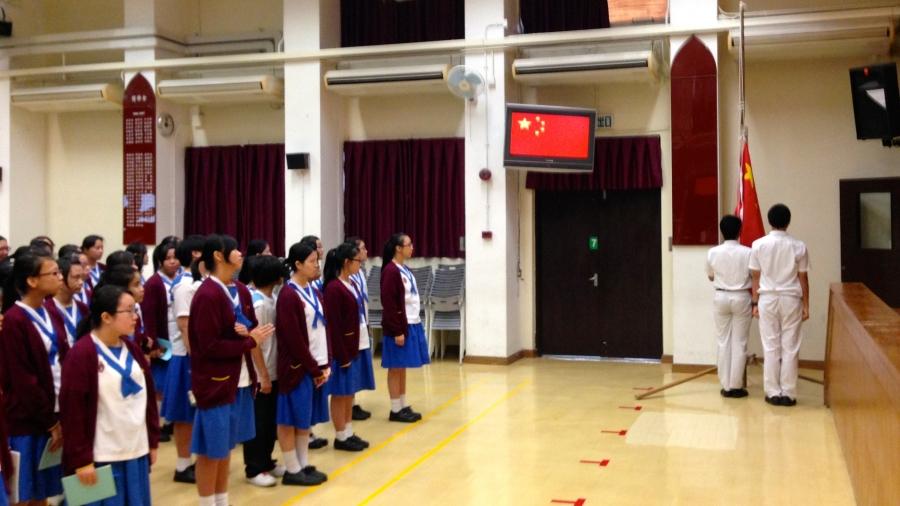 Middle school students at Lee Kau Yan Memorial School participate in a flag-raising ceremony.