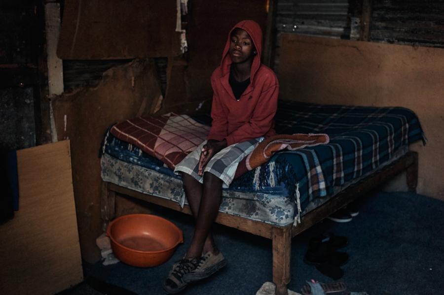 Mcepisi, 15, after his mother, Lutango, died of tuberculosis in 2013. His younger sister was adapted by her biological father. He now lives all alone and is supported by neighbors.