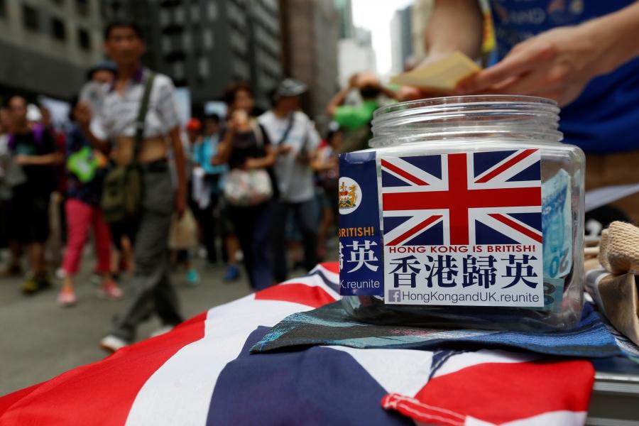 A campaigner for Hong Kong-UK reunification counts donations on July 1, 2016 — the day marking the 19th anniversary of Hong Kong's handover to Chinese sovereignty from British rule. 