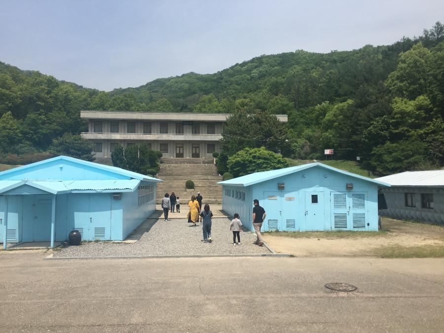 an outdoor film set that features a replica of the Joint Security Area 