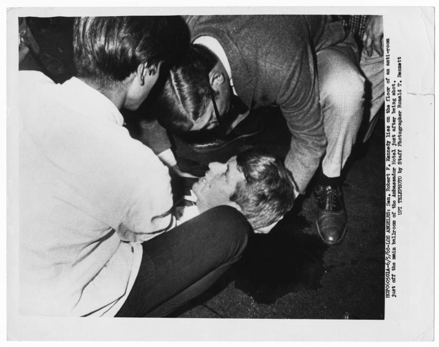 Robert Kennedy’s wounded head is cradled as he lies on the kitchen passageway floor just after being shot.